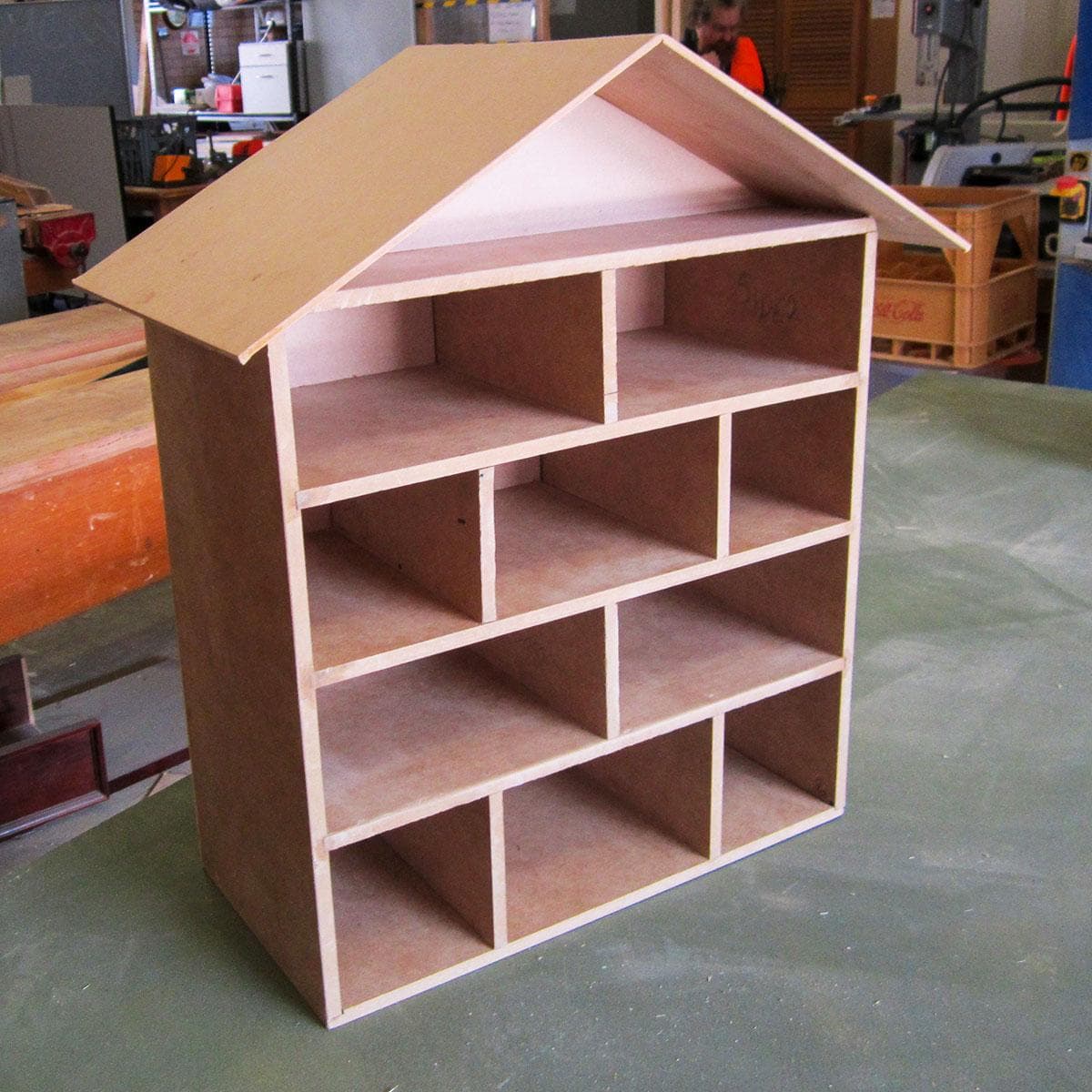 Small wooden cubby shelf with a roof